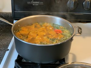 pot of Jamaican pumpkin soup simmering