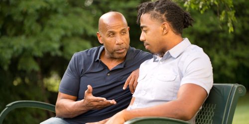 someone giving advice on a park bench