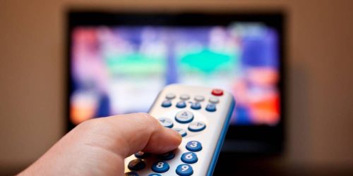 person using remote to find TV show