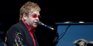Elton John at a piano