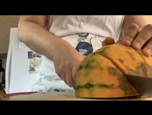 chopping a pumpkin for soup